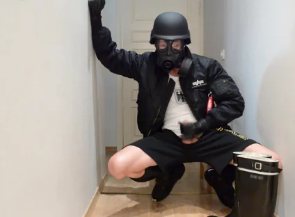 Gas masked guy cums on his rubber boots