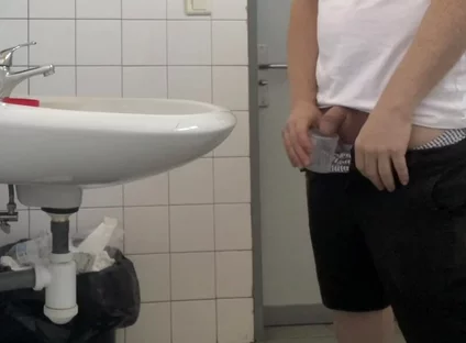 Guy Taking a Urine Sample in Hospital Toilets