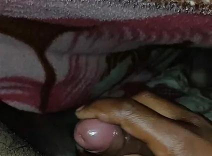 Big Boss massaging penis oil under the blanket
