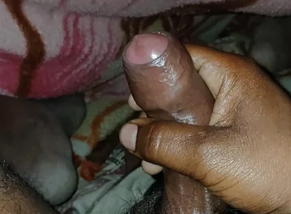 Big Boss massaging penis oil under the blanket