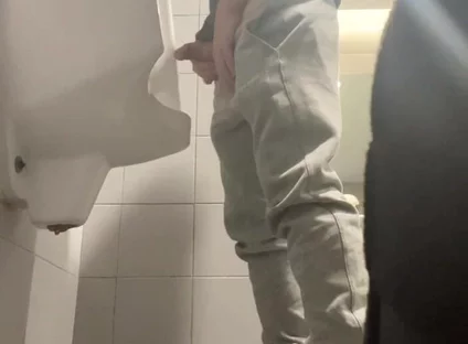 2 Boys in Sneakers Having Fun at Public Toilets' Urinal