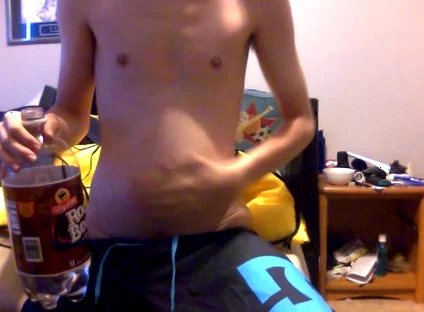Young Guy Fills His Stomach with Water