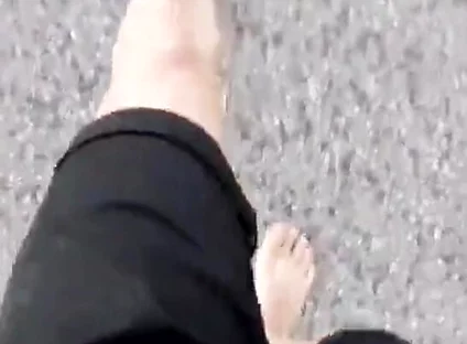 Jon Arteen Walks Barefoot on the Street Outdoors, the Boy Is Barefoot in the Crowded Tram to the Town Center